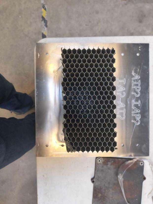 Crushed honeycomb bonded to an aluminum plate after testing