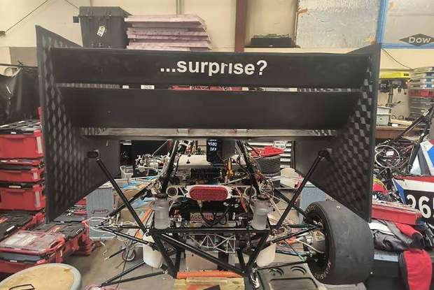 Rear wing mounted on the MIT Motorsports car in the shop