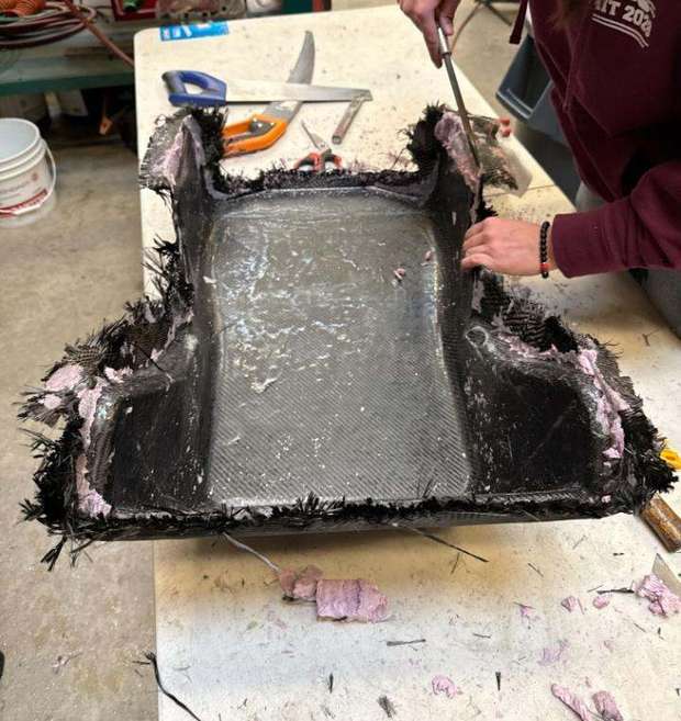 Cured carbon seat shell with foam being removed