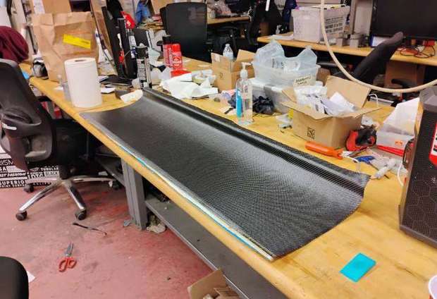 Cured carbon fiber wing element on a workbench